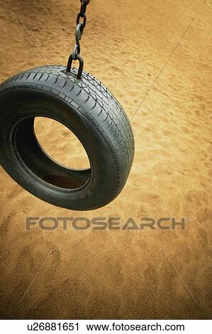 A tire swing in a playground View Large Photo Image Stock Image - A tire swing in a playground. Fotosearch