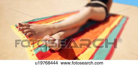 A woman sunbathing View Large Photo Image Picture - A woman sunbathing. Fotosearch