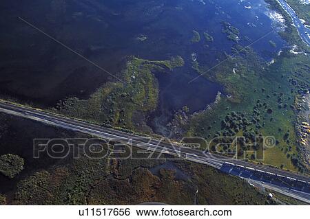 Stock Photograph - Aerial view of train tracks and water. Fotosearch