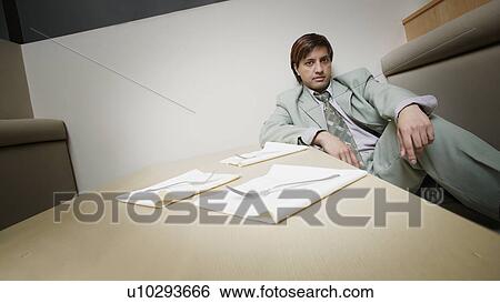 Asian man waiting in restaurant booth View Large Photo Image Stock Photograph - Asian man waiting in restaurant booth. Fotosearch
