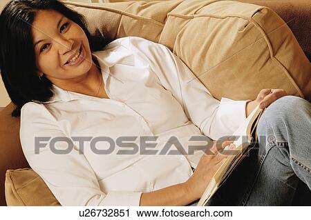 Attractive woman relaxing and reading View Large Photo Image Stock Image - Attractive woman relaxing and reading. Fotosearch
