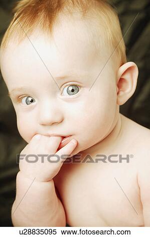 Baby chews on fingers View Large Photo Image Stock Photography - Baby chews on fingers. Fotosearch