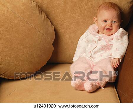 Baby girl smiles in chair View Large Photo Image Stock Image - Baby girl smiles in chair. Fotosearch