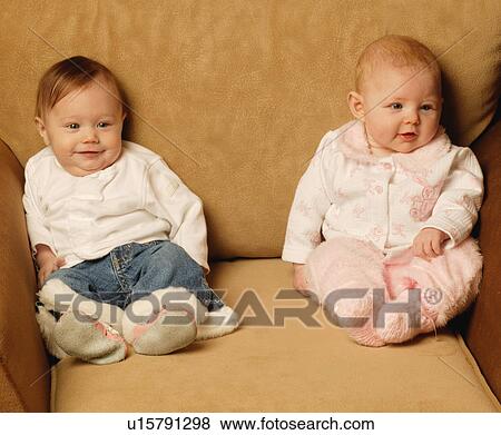 Baby girls sitting together View Large Photo Image Stock Photo - Baby girls sitting together. Fotosearch