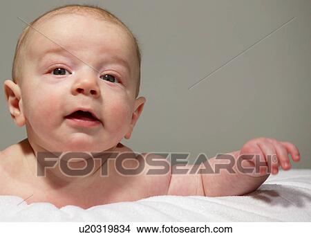 Picture - Baby lying on tummy. Fotosearch