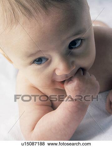 Stock Photo - Baby sucking on fingers. Fotosearch