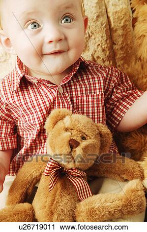 Stock Image - Baby with a teddy bear. Fotosearch