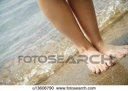 Stock Image - Barefoot on the beach. Fotosearch