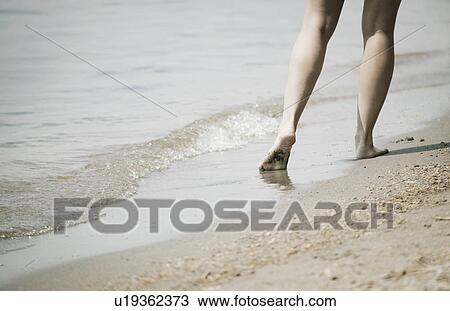 Stock Image - Barefoot on the beach. Fotosearch