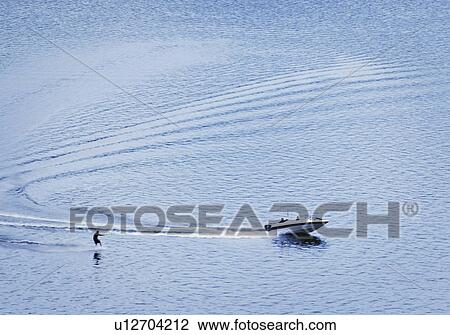 Boat pulling a water-skier View Large Photo Image Stock Image - Boat pulling a water-skier. Fotosearch