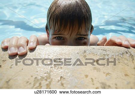 Boy creeps up on side of pool View Large Photo Image Stock Image - Boy creeps up on side of pool. Fotosearch