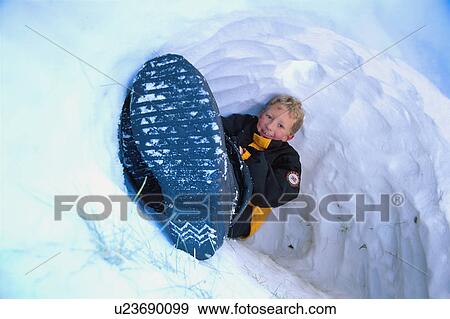 Stock Photo - Boy in snow cave. Fotosearch