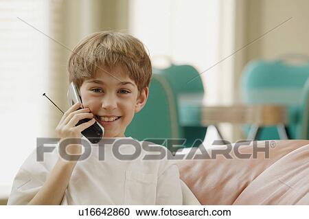 Stock Image - Boy talking on the phone. Fotosearch