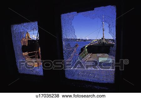 Stock Photo - Broken-down boat with shattered windows. Fotosearch