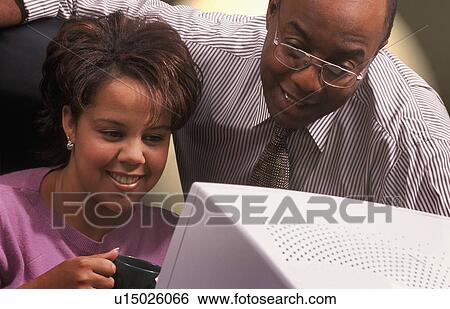 Stock Photograph - Business People in front of computer monitor. Fotosearch