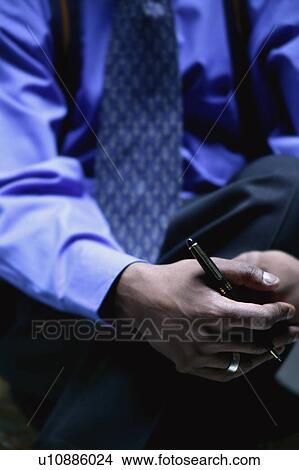 Businessman holds pen View Large Photo Image Picture - Businessman holds pen. Fotosearch