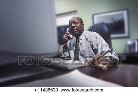Businessman in front of computer View Large Photo Image Stock Image - Businessman in front of computer. Fotosearch