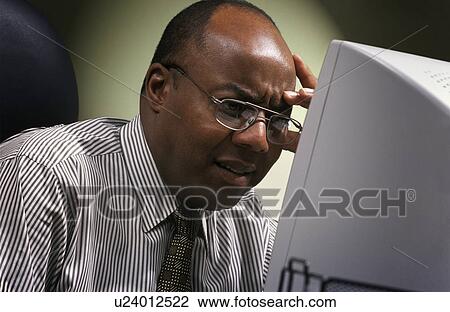 Stock Image - Businessman in front of computer. Fotosearch