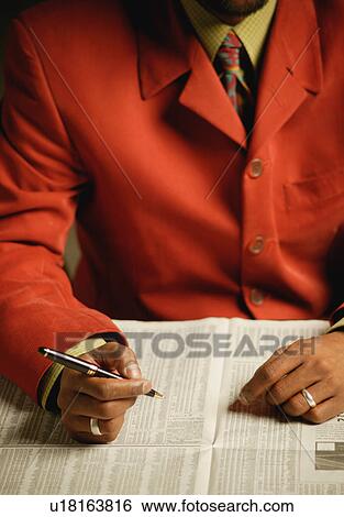 Businessman looks at the newspaper View Large Photo Image Stock Photograph - Businessman looks at the newspaper. Fotosearch
