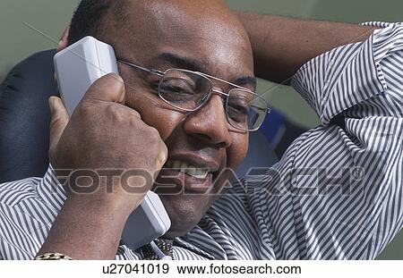 Stock Photo - Businessman pleased on phone. Fotosearch