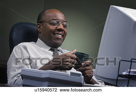 Businessman pleased with the day's work View Large Photo Image Stock Image - Businessman pleased with the day's work. Fotosearch