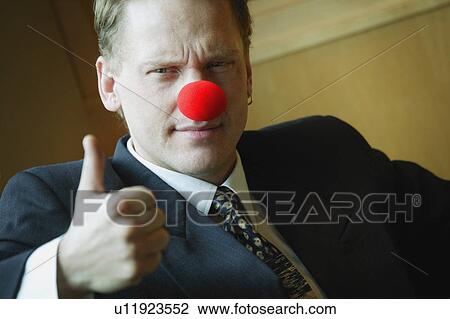 Stock Image - Businessman wearing clowning around. Fotosearch