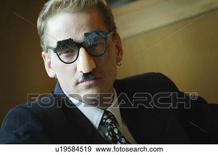 Businessman wearing Groucho Marx disguise View Large Photo Image Stock Photo - Businessman wearing Groucho Marx disguise. Fotosearch