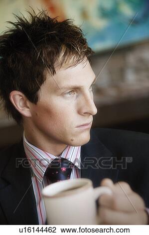 Businessman with a cup of coffee View Large Photo Image Stock Image - Businessman with a cup of coffee. Fotosearch