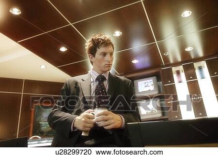 Stock Image - Businessman with a cup of coffee. Fotosearch