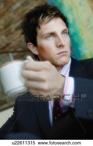 Businessman with a cup of coffee View Large Photo Image Stock Photography - Businessman with a cup of coffee. Fotosearch
