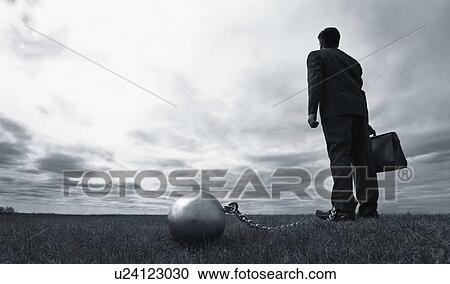 Stock Image - Businessman with ball and chain. Fotosearch