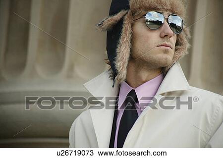 Stock Image - Businessman with hat and overcoat. Fotosearch