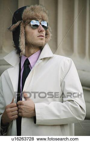 Stock Photo - Businessman with hat and overcoat. Fotosearch