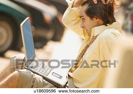 Businessman with lap top computer View Large Photo Image Stock Photograph - Businessman with lap top computer. Fotosearch
