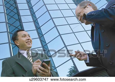 Stock Photo - Businessmen schedule meeting. Fotosearch