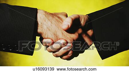 Stock Photo - Businessmen shake hands. Fotosearch