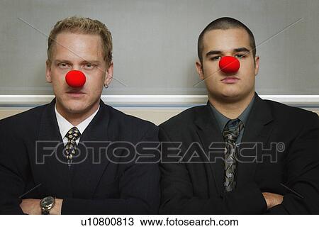 Businessmen wearing as red nose looking serious View Large Photo Image Stock Image - Businessmen wearing as red nose looking serious. Fotosearch