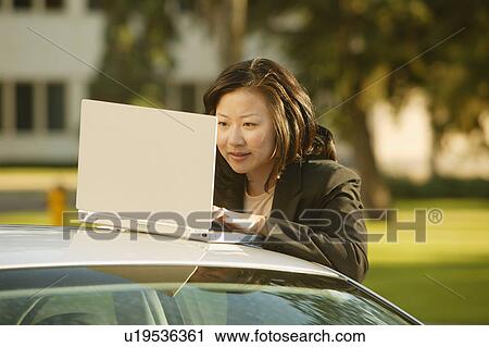 Stock Image - Businesswoman does last minute preparations. Fotosearch