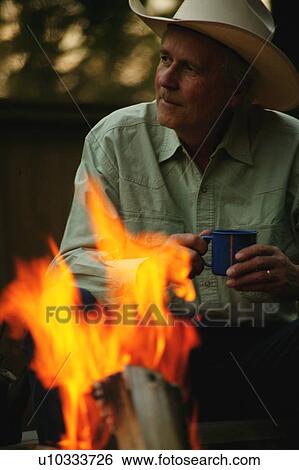 Stock Photograph - Camp fire at the end of a long day. Fotosearch