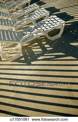 Stock Image - Chairs in the sun. Fotosearch