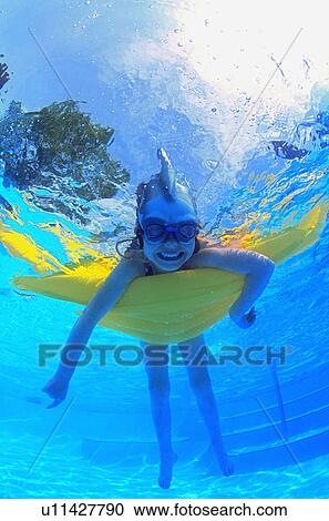 Stock Image - Child in swimming pool. Fotosearch