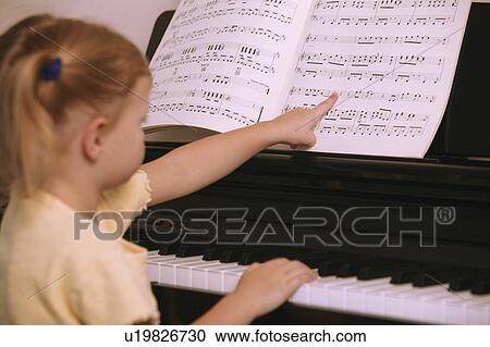 Child learns to play the piano View Large Photo Image Stock Image - Child learns to play the piano. Fotosearch