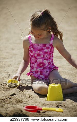 Child playing in the sand View Large Photo Image Stock Photograph - Child playing in the sand. Fotosearch