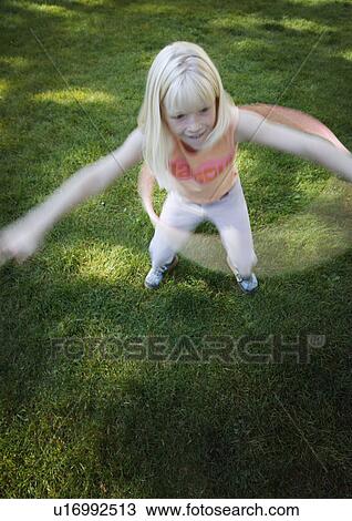 Stock Image - Child plays with hoop. Fotosearch
