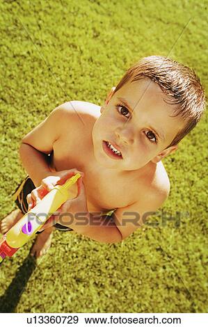 Stock Photo - Child plays with water gun. Fotosearch