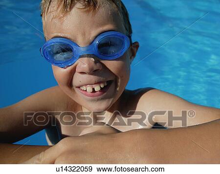 Stock Photo - Child smiles in the swimming pool. Fotosearch