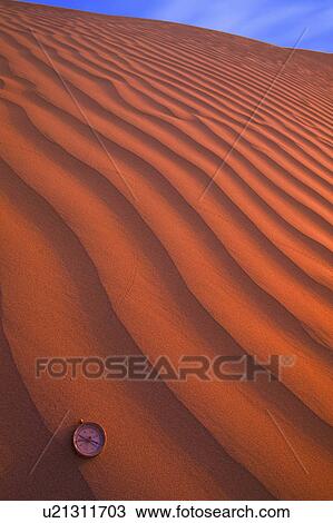 Compass pointing direction in the waves of desert sand View Large Photo Image Stock Image - Compass pointing direction in the waves of desert sand. Fotosearch