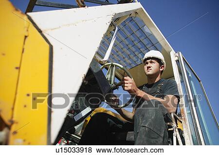 Stock Photo - Construction worker using equipment. Fotosearch