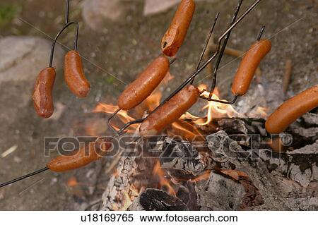 Stock Photography - Cooking sausages over charcoal. Fotosearch