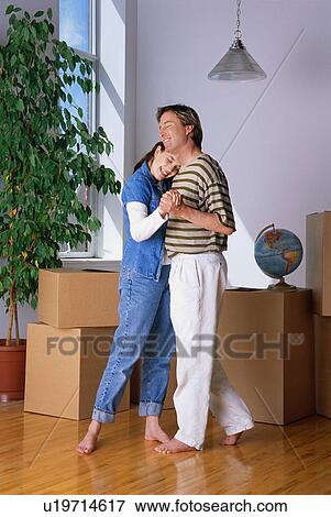 Stock Photo - Couple dancing in new home. Fotosearch
